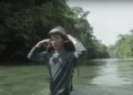 Un migrante chino cruza un río en la zona selvática del Tapón del Darién en Panamá.